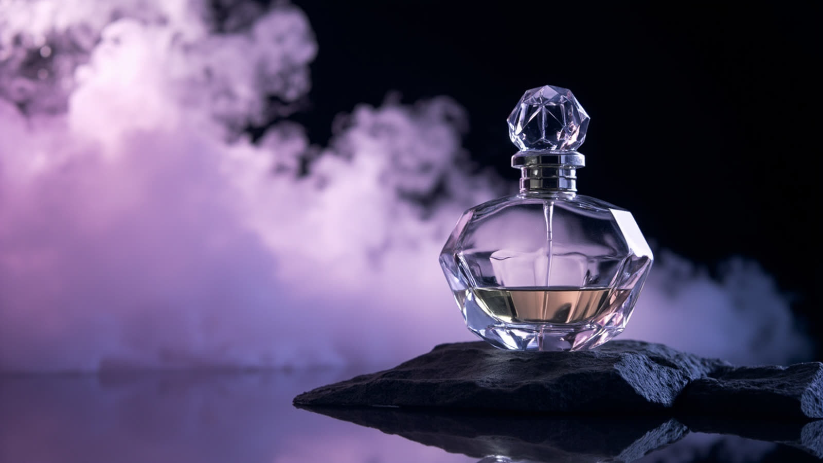Flacon on dark stone before drifting lilac smoke